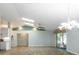 Spacious living area featuring vaulted ceilings, light walls, and sliding doors to screened room at 33516 Overton Dr, Leesburg, FL 34788