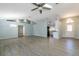 Airy open-concept space with vaulted ceilings, light walls, and seamless transition to kitchen at 33516 Overton Dr, Leesburg, FL 34788
