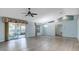 Open living room with light blue walls, wood floors, and sliding glass doors to screened room at 33516 Overton Dr, Leesburg, FL 34788