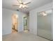 Main bedroom features carpet, an ensuite bathroom and mirrored closet at 33516 Overton Dr, Leesburg, FL 34788