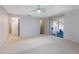 Spacious main bedroom with neutral carpet, sliding glass doors, fan and ensuite access at 33516 Overton Dr, Leesburg, FL 34788