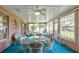 Enclosed sunroom area with ample seating, a ceiling fan, and multiple windows at 33516 Overton Dr, Leesburg, FL 34788
