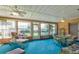 Cozy sunroom featuring light fixtures, multiple windows with backyard views, and comfortable seating at 33516 Overton Dr, Leesburg, FL 34788