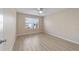 Bright bedroom featuring sleek, light-colored floors and a ceiling fan at 2552 English Ivy Cir, The Villages, FL 32162