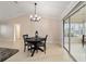 Bright dining area featuring a black table set near sliding glass doors at 2552 English Ivy Cir, The Villages, FL 32162