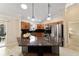 Bright kitchen featuring stainless steel appliances, granite countertops, and pendant lights at 2552 English Ivy Cir, The Villages, FL 32162