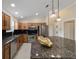 Modern kitchen with stainless steel appliances, dark backsplash, and granite countertops at 2552 English Ivy Cir, The Villages, FL 32162