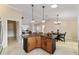 Kitchen featuring granite countertops, wood cabinets and a breakfast bar with seating at 2552 English Ivy Cir, The Villages, FL 32162
