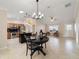 Open concept kitchen and living area with tile flooring and an island at 2552 English Ivy Cir, The Villages, FL 32162