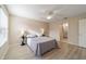 Bedroom with neutral paint and a door to the ensuite bath at 2552 English Ivy Cir, The Villages, FL 32162