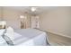 Bedroom with a fan, walk-in closets, and wood-look flooring at 2552 English Ivy Cir, The Villages, FL 32162