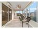Bright sunroom with many windows offering views of the neighborhood at 2552 English Ivy Cir, The Villages, FL 32162