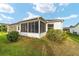 Exterior view of a sunroom addition to the home with screened windows at 2552 English Ivy Cir, The Villages, FL 32162