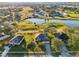 Gorgeous aerial view of home next to golf course, with serene lake and lush greenery at 36729 Alaqua Ct, Eustis, FL 32736