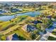 Stunning aerial view of a home nestled in a golf course community with a serene lake at 36729 Alaqua Ct, Eustis, FL 32736