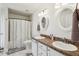 Well-lit bathroom with a double vanity, granite countertops, and a shower-tub combo at 36729 Alaqua Ct, Eustis, FL 32736