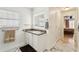 Well-lit bathroom with a granite vanity, modern mirror, and marble floors at 36729 Alaqua Ct, Eustis, FL 32736