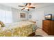 Cozy bedroom with ceiling fan, soft natural light, double closet, and decorative accents at 36729 Alaqua Ct, Eustis, FL 32736