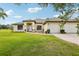 Well-maintained single-story home with a manicured lawn and a three-car garage at 36729 Alaqua Ct, Eustis, FL 32736