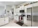 Bright kitchen featuring stylish pendant lighting, island seating, and stainless steel appliances at 36729 Alaqua Ct, Eustis, FL 32736