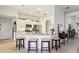 Bright kitchen featuring stylish pendant lighting, island seating, and stainless steel appliances at 36729 Alaqua Ct, Eustis, FL 32736