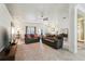 Spacious living room with two sofas, large rug, and a view to the kitchen and dining area at 36729 Alaqua Ct, Eustis, FL 32736