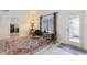 Seating area with decorative rug, natural light, and view of the front door at 36729 Alaqua Ct, Eustis, FL 32736