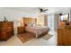 Comfortable primary bedroom with wood furnishings, decorative bedding, and natural light at 36729 Alaqua Ct, Eustis, FL 32736