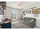 Inviting office space with custom shelving, comfortable seating, and natural light at 36729 Alaqua Ct, Eustis, FL 32736