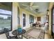 Screened in lanai, with ceiling fans, table with chairs, and decorative accents at 36729 Alaqua Ct, Eustis, FL 32736