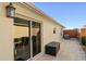 Small back patio with sliding glass door access and storage chest at 5569 Bougainvillea Ave, The Villages, FL 32163