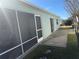 Home exterior showcasing a screened patio and spacious backyard at 718 Villita Ln, Lady Lake, FL 32159