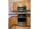 Modern kitchen with stainless steel appliances and wood cabinets at 718 Villita Ln, Lady Lake, FL 32159