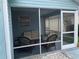 Relaxing screened porch with wicker furniture, perfect for enjoying the outdoors at 718 Villita Ln, Lady Lake, FL 32159