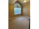 Bedroom with a fan, carpeted floor and arched window at 12144 Bruceton Way # 101, Orlando, FL 32828