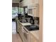 White kitchen appliances, including a microwave and stove, on countertops beside the sink, creating a cooking space at 12144 Bruceton Way # 101, Orlando, FL 32828