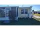 Exterior view of the house showing a screened porch and propane tank at 1432 South Shore Dr, Tavares, FL 32778