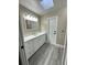 Modern bathroom with white vanity and vinyl flooring at 1566 Lawndale Cir, Winter Park, FL 32792