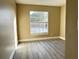 Bedroom with large window and vinyl flooring at 1566 Lawndale Cir, Winter Park, FL 32792