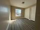 Bedroom with gray wood flooring, a bright window, neutral walls, and double closets at 1566 Lawndale Cir, Winter Park, FL 32792