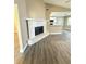 White brick fireplace in living room with wood-look flooring at 1566 Lawndale Cir, Winter Park, FL 32792