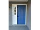 Blue front door with white sidelight and black hardware at 1566 Lawndale Cir, Winter Park, FL 32792