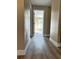 Long hallway with vinyl flooring leading to bedrooms at 1566 Lawndale Cir, Winter Park, FL 32792