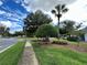 Beautifully landscaped neighborhood street featuring lush green grass, sidewalks, and mature trees at 1566 Lawndale Cir, Winter Park, FL 32792