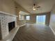 Bright living room with a view of the slider, fireplace and the kitchen at 1566 Lawndale Cir, Winter Park, FL 32792