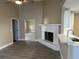 Open-concept living room with painted brick fireplace and seamlessly connected kitchen at 1566 Lawndale Cir, Winter Park, FL 32792