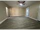 Living room offers gray wood flooring, neutral paint, and a sliding door that opens to a lanai at 1566 Lawndale Cir, Winter Park, FL 32792