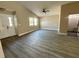 Bright living room featuring a vaulted ceiling, fan and stylish gray flooring at 1566 Lawndale Cir, Winter Park, FL 32792