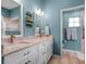 Bright bathroom featuring double vanity and a glass shower at 20744 Queen Alexandra Dr, Leesburg, FL 34748