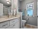 Bathroom featuring decorative window and vanity with white cabinets at 20744 Queen Alexandra Dr, Leesburg, FL 34748